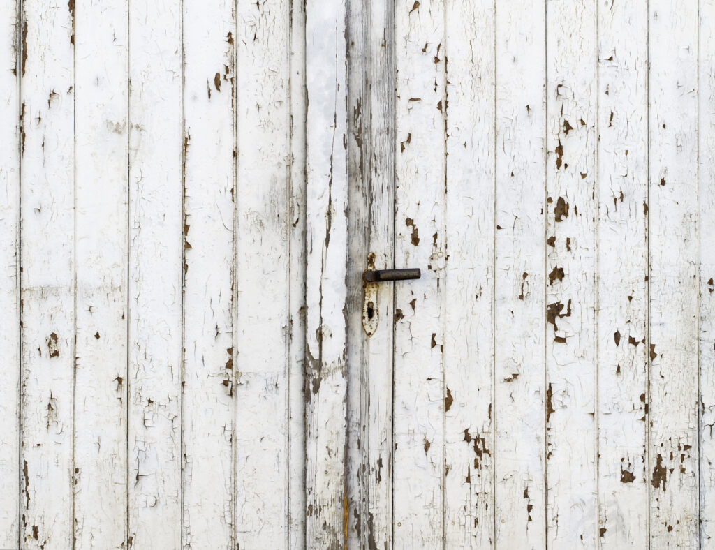 Peeling paint on an exterior door, which is a common sign that a home may need exterior painting services.