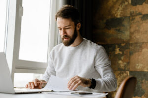 A man researching how he can reduce the cost of residential painting for his home. 