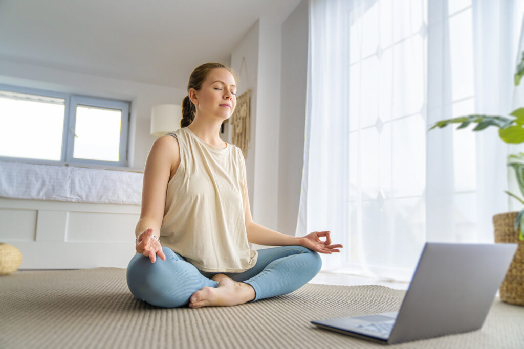 A woman meditating in her home after her interior painting Wichita KS contractor finished painting her home. 