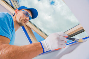 Commercial painting contractors near me paints a vibrant red wall with precision and care.