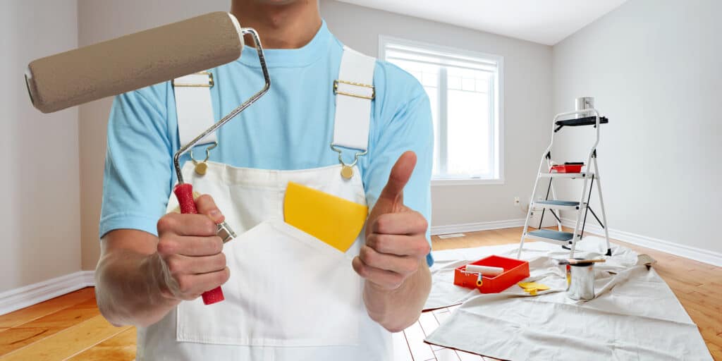 A house painter giving a thumbs-up, symbolizing the quality work of painters in Wichita.