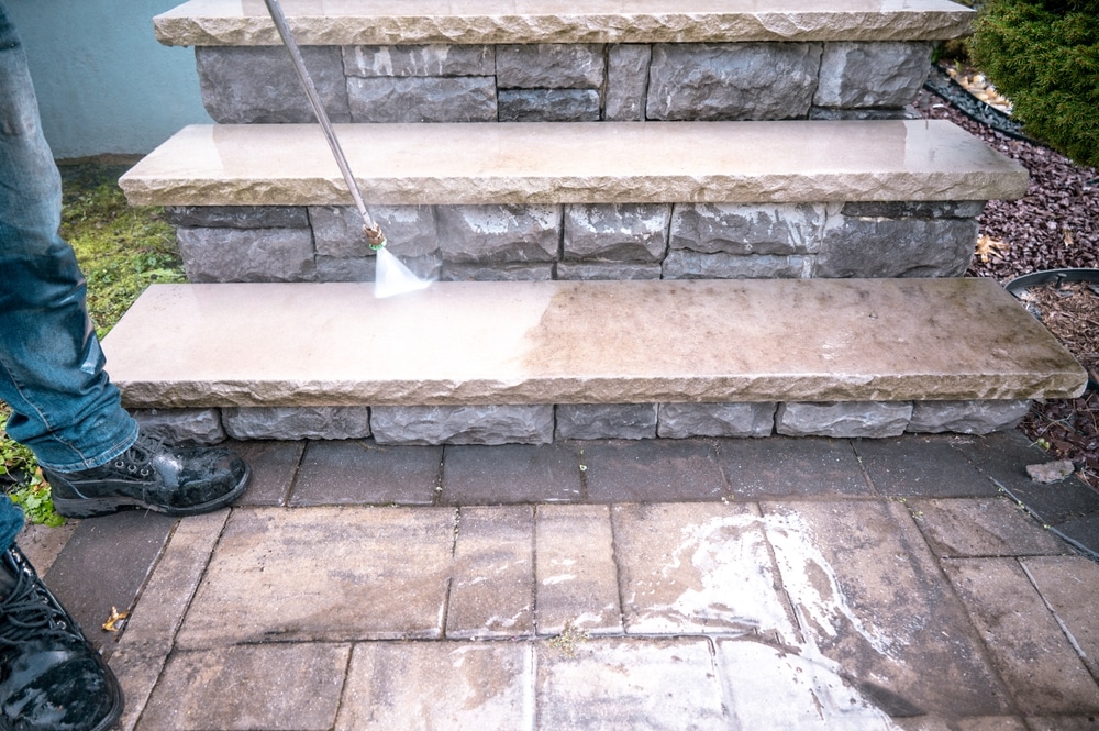 Stairs being cleaned with professional power washing services to protect and enhance property value.