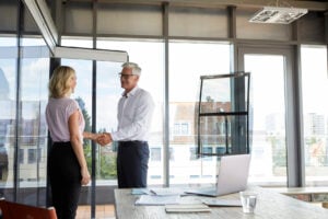 Two business partners in agreement after analyzing a list of 'exterior painters near me.'