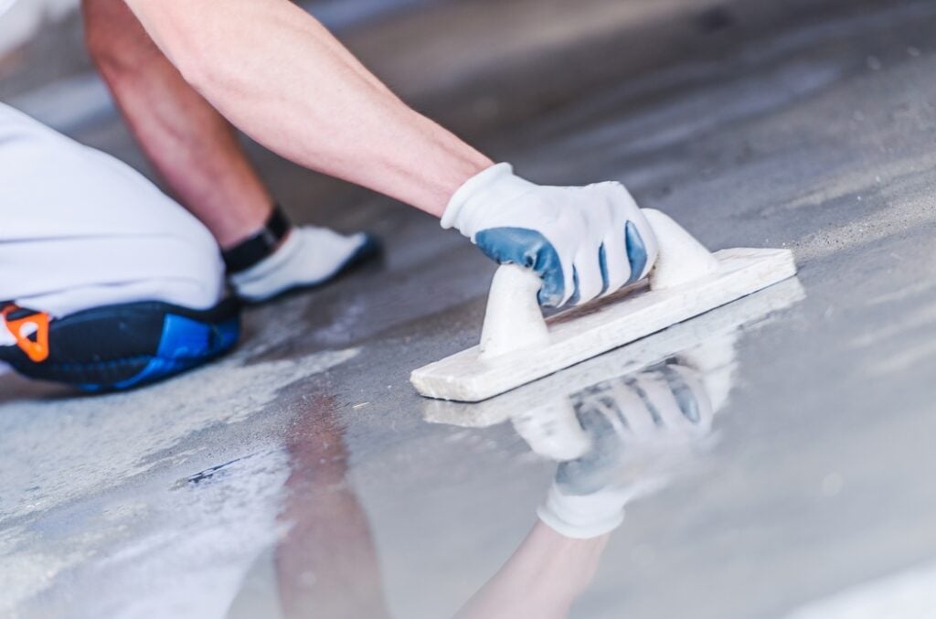 K5, one of the best Wichita painters, has a staff member applying floor sealer.