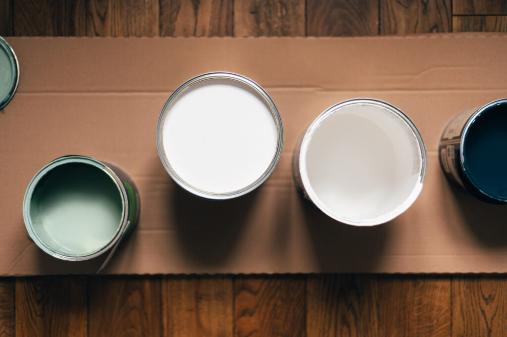 Paint cans with paint, which are to be used for house painting services.