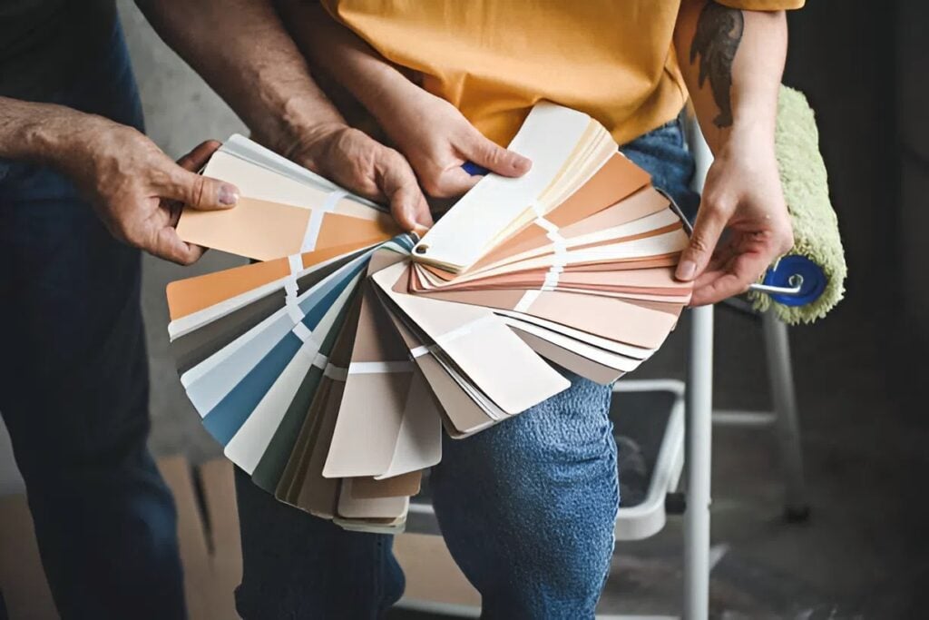 House painter in Wichita, KS, reviewing paint swatches with homeowner during interior color consultation