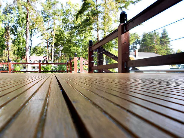 Freshly stained commercial wood deck with rich cedar tones and a durable protective finish by a painting company in Newton, KS.