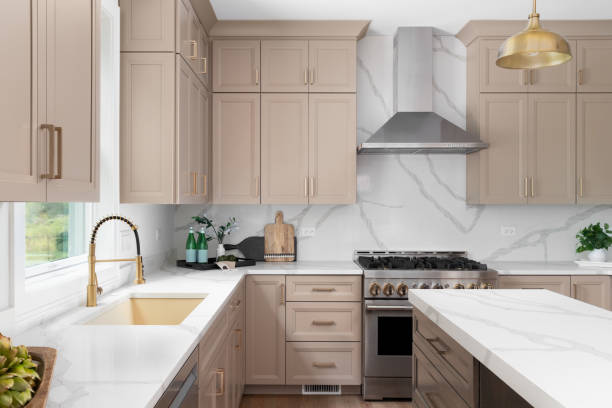 Modern kitchen with warm greige painted cabinets and matching trim by an interior painter in Derby, KS.