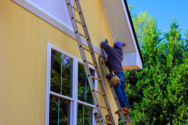 Siding repair and exterior painting work on a home by an exterior painter in Wichita, KS.