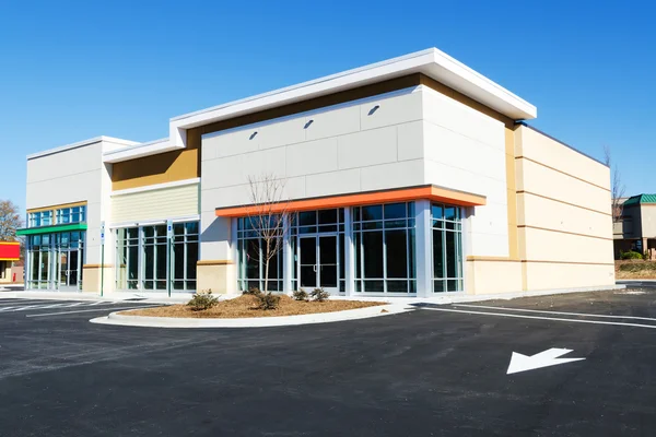 Commercial building with white and beige exterior colors and smooth painted finishes by a painter in Derby, KS.